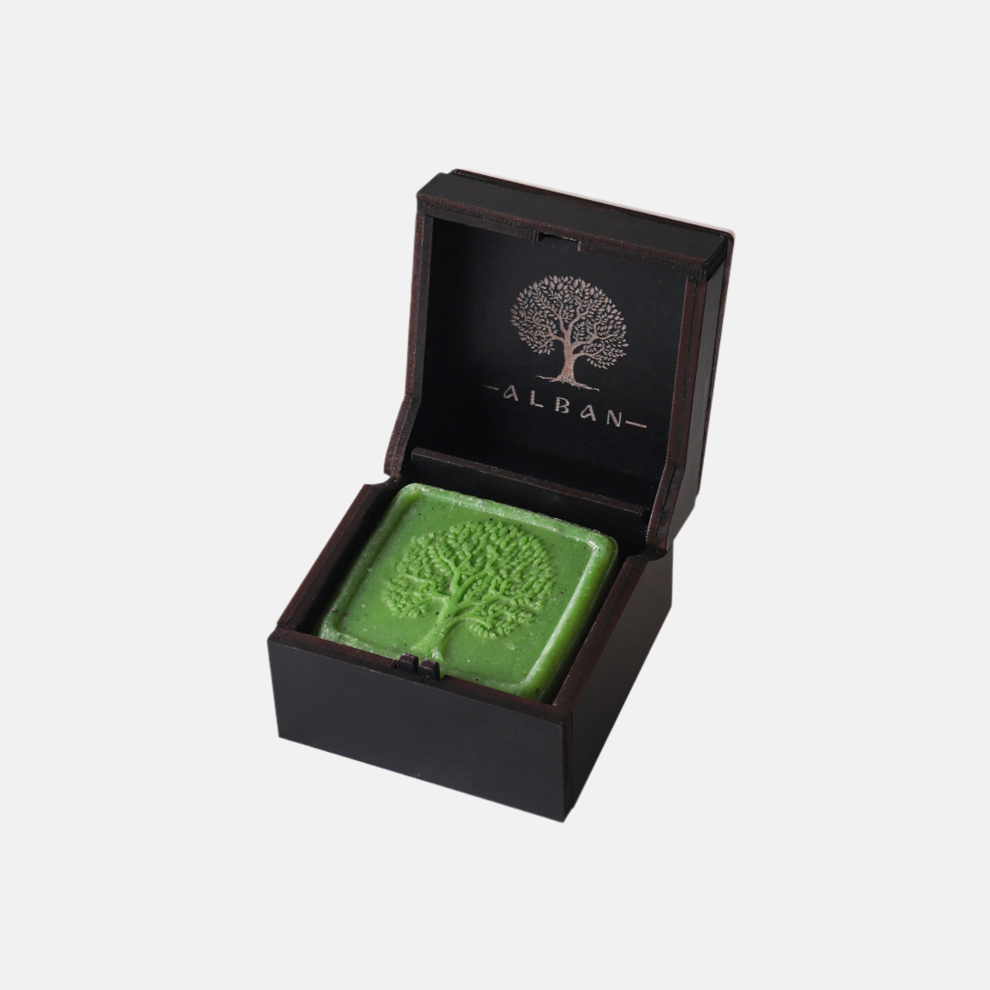 Green soap bar with tree design in a black box labeled 'Alban' on a white background